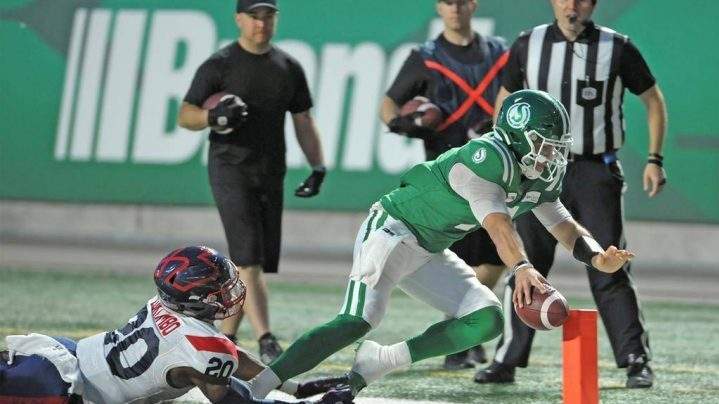 Saskatchewan Roughriders quarterback Cody Fajardo runs in a touchdown passed Montreal Alouettes linebacker Boseko Lokombo (20) during second half CFL action at Mosaic Stadium in Regina on Saturday, Sept. 14, 2019.