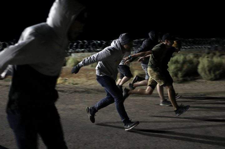 People do the “Naruto run” at the gates of Area 51 on Sept. 20, 2019.