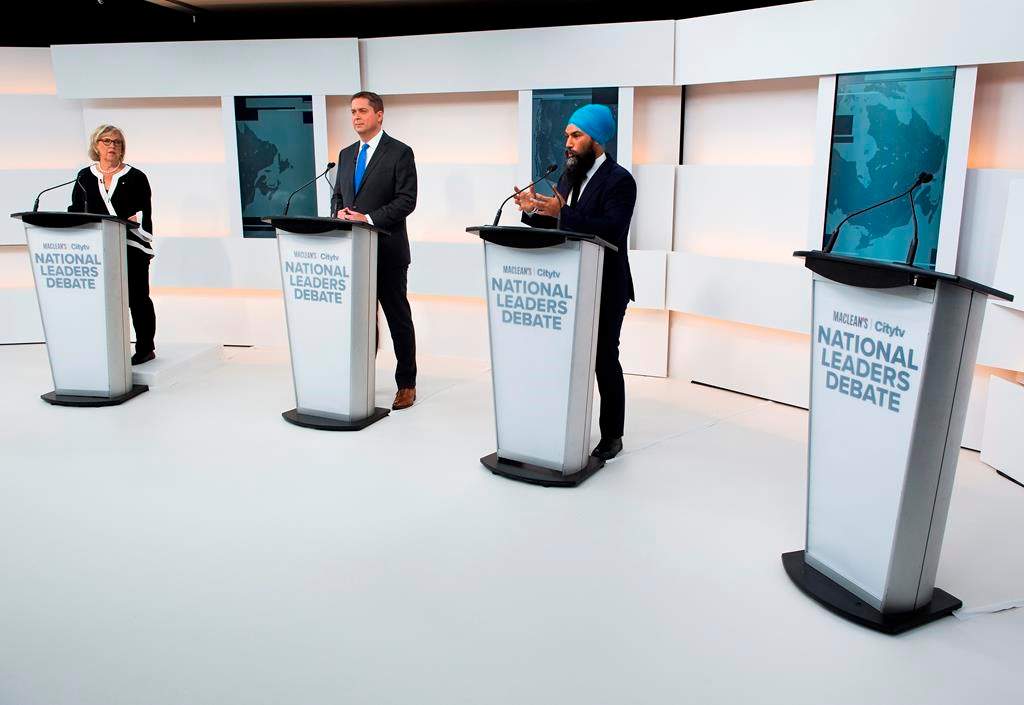 A empty podium stand where Liberal Leader Justin Trudeau turned down the invitation for the debate as Green Party Leader Elizabeth May, left, Conservative Leader Andrew Scheer, centre, and NDP Leader Jagmeet Singh take part during the Maclean's/Citytv National Leaders Debate in Toronto on Thursday, September 12, 2019.