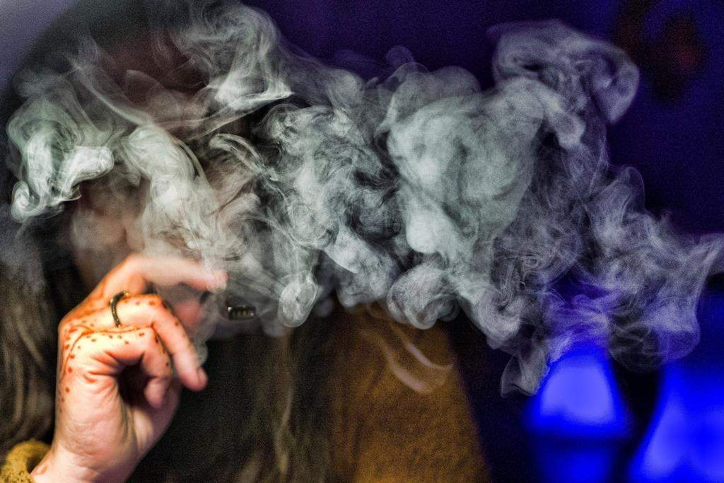 FILE - In this Saturday, Dec. 22, 2018 file photo, a woman takes a puff from a cannabis vape pen in Los Angeles. On Friday, Sept. 6, 2019, U.S. health officials are again urging people to stop vaping until they figure out why some are coming down with serious breathing illnesses.