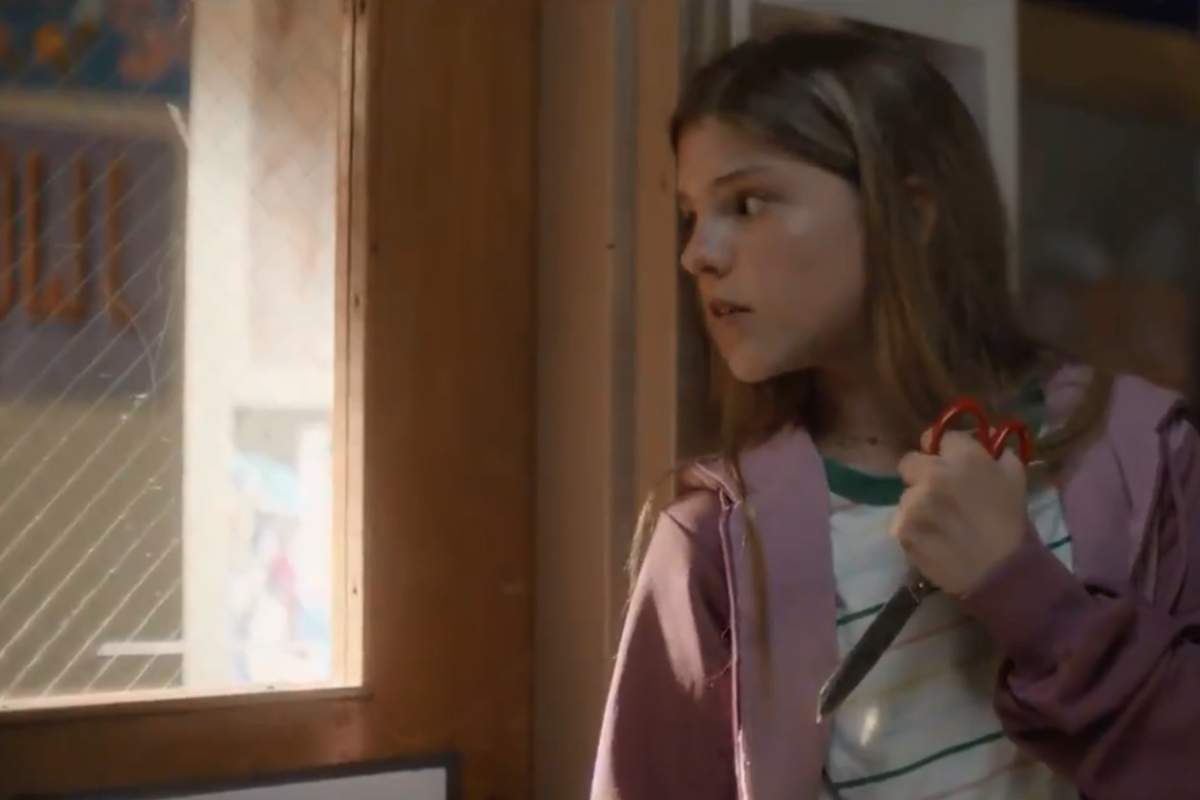 A girl waits to attack a mass shooter with her new scissors in this image from a PSA video.