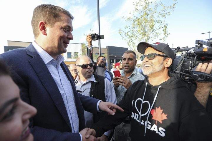 Conservative Party of Canada Leader Andrew Scheer points to a man’s shirt during a campaign stop in Calgary, Alta., on Sept. 16, 2019.