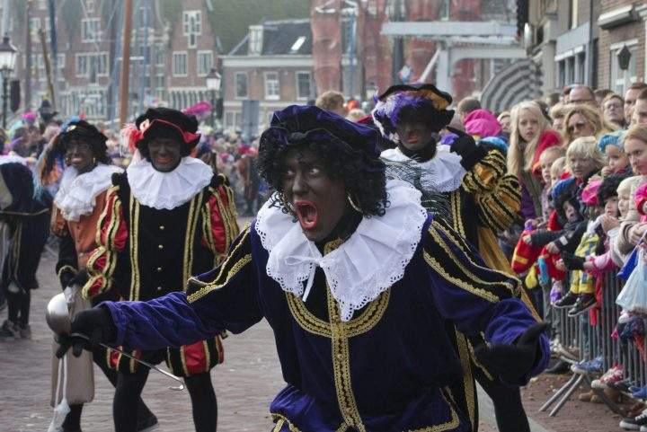 A "Zwarte Piet" or "Black Pete", jokes with children after arriving with Sinterklaas, or Saint Nicholas, by steamboat in Hoorn, north-western Netherlands, Saturday Nov. 16, 2013. 