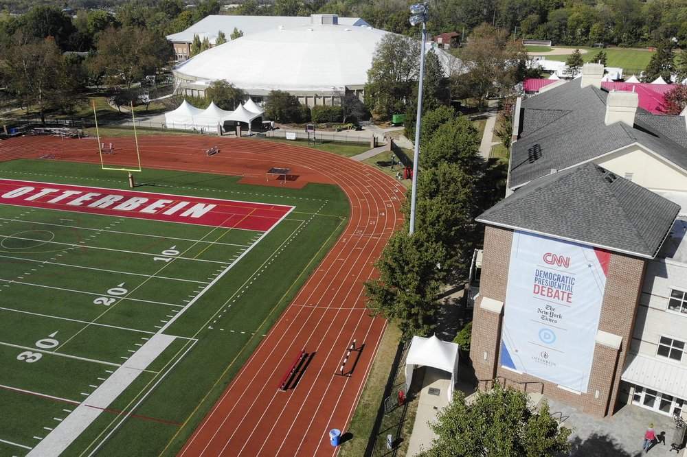 A CNN sign hangs on the side of a buidling near an athletic field outside the Clements Recreation Center where the CNN/New York Times will host the Democratic presidential primary debate at Otterbein University, Monday, Oct. 14, 2019, in Westerville, Ohio. 