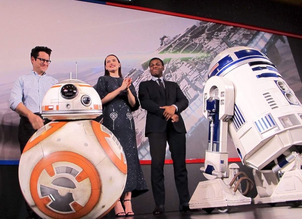 (L-R) J.J. Abrams, Daisy Ridley and John Boyega with ‘Star Wars’ droids BB-8, left, and R2-D2.