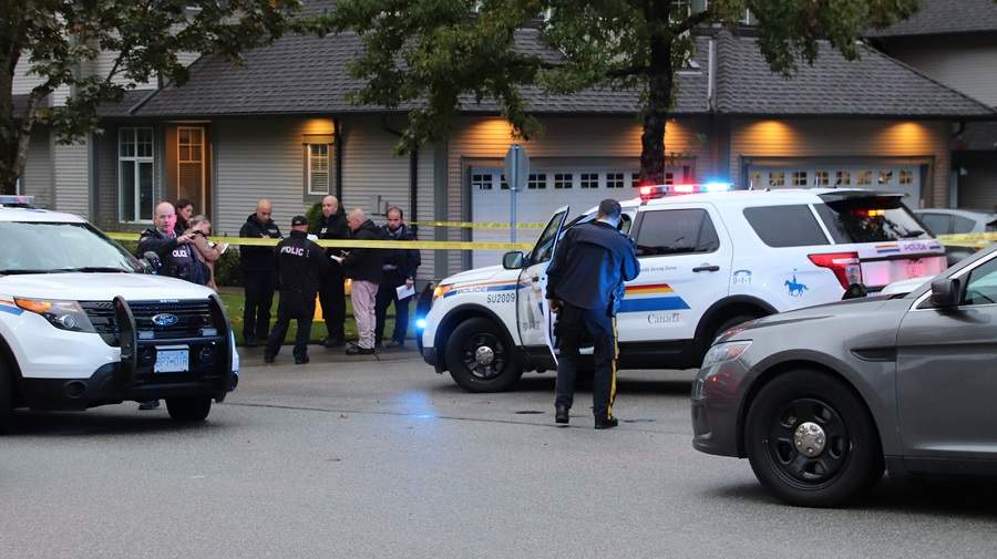 Surrey RCMP and homicide investigators outside a Newton home on Oct. 4, 2019, where a woman was found dead and a man was arrested.