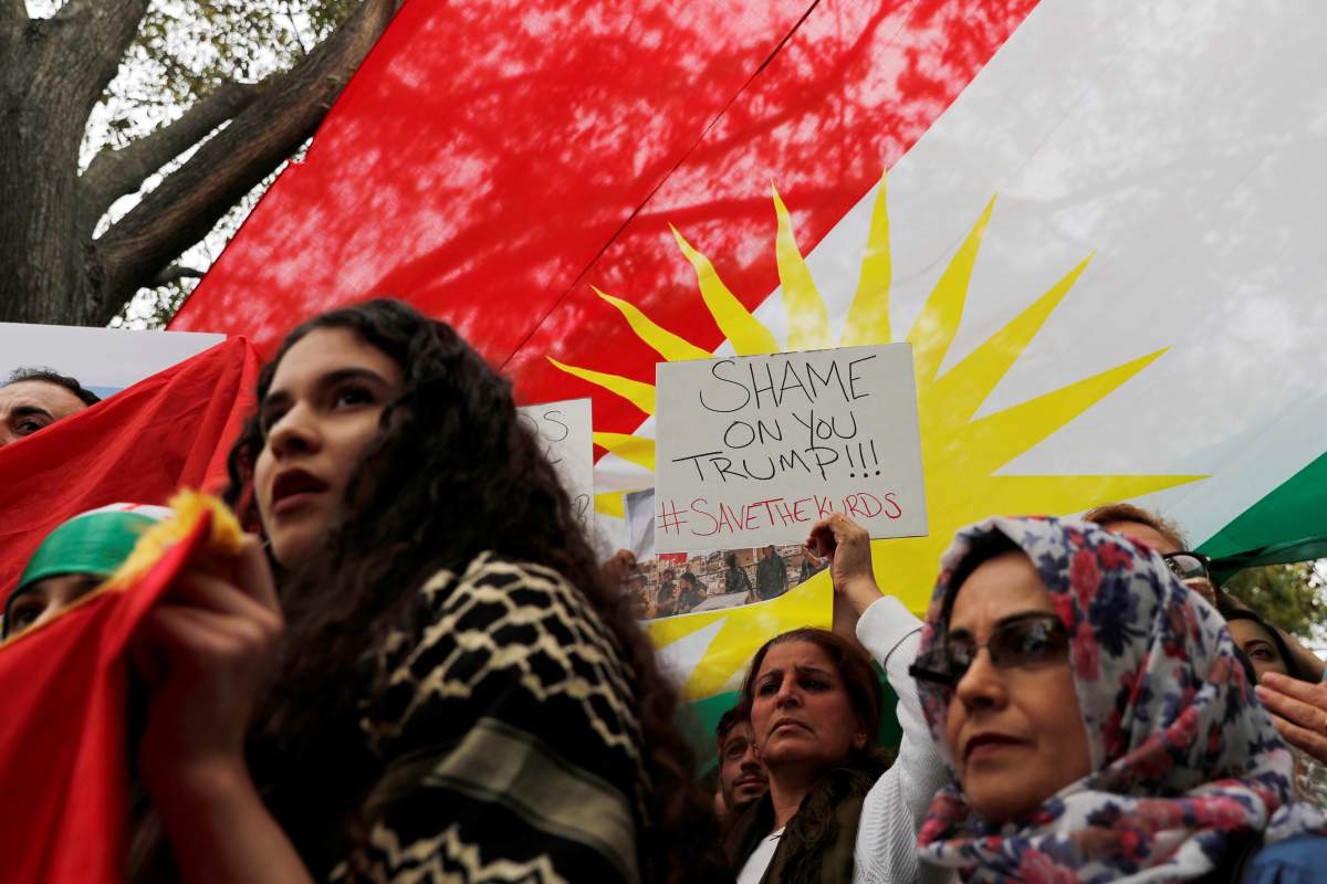 Members of The American Rojava Center for Democracy, an organization that advocates for freedom, democracy, and peace in Syria, take part with other activists in a rally to protest Turkey’s incursion into Kurdish-controlled northeast Syria and urge U.S. action against Turkey, outside the White House in Washington, U.S, October 12, 2019.