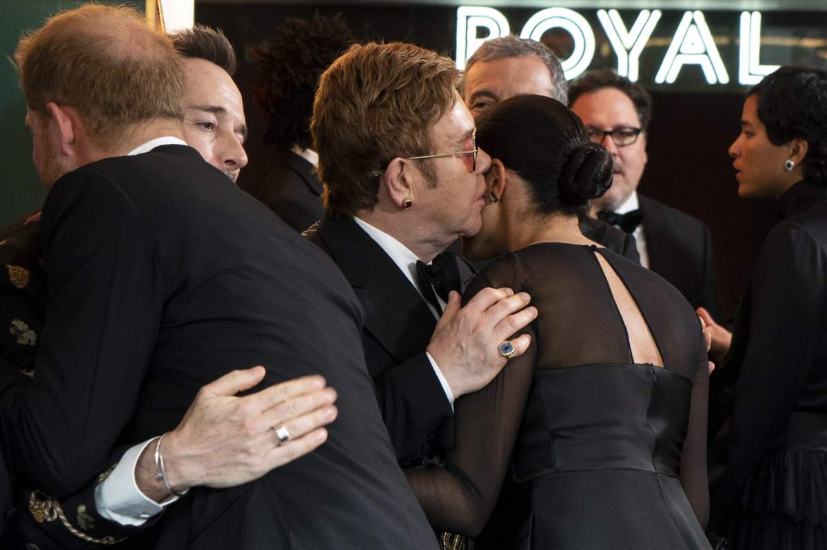 The Duke and Duchess of Sussex embrace David Furnish and Elton John at the European Premiere of Disney’s ‘The Lion King’ at the Odeon Leicester Square in London, England.