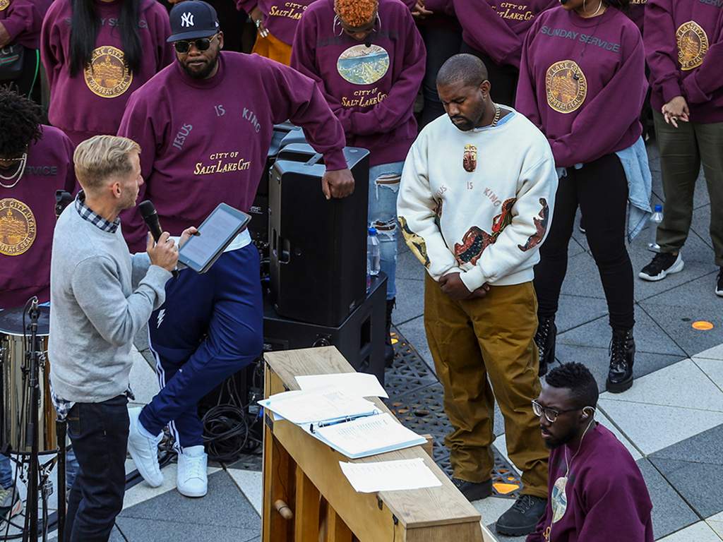 Kanye West (R) bows his head in prayer during his ‘Sunday Service’ at The Gateway in Salt Lake City, Utah, on Saturday, Oct. 5, 2019.