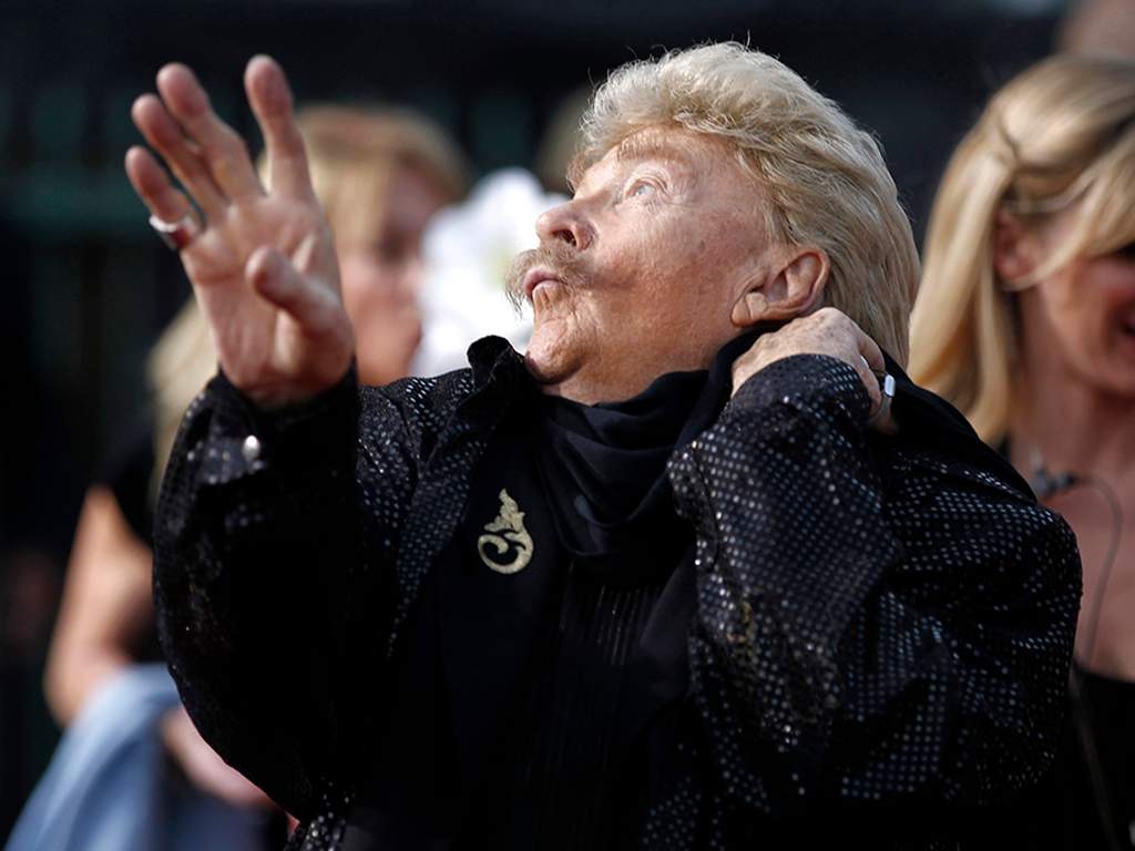 In this Friday, Jan. 14, 2011, file photo, Rip Taylor arrives at the 16th Annual Critics’ Choice Movie Awards in Los Angeles. Taylor, the mustached comedian with a fondness for confetti-throwing who became a television game show mainstay in the 1970s, died Sunday, Oct. 6, 2019. He was 88.