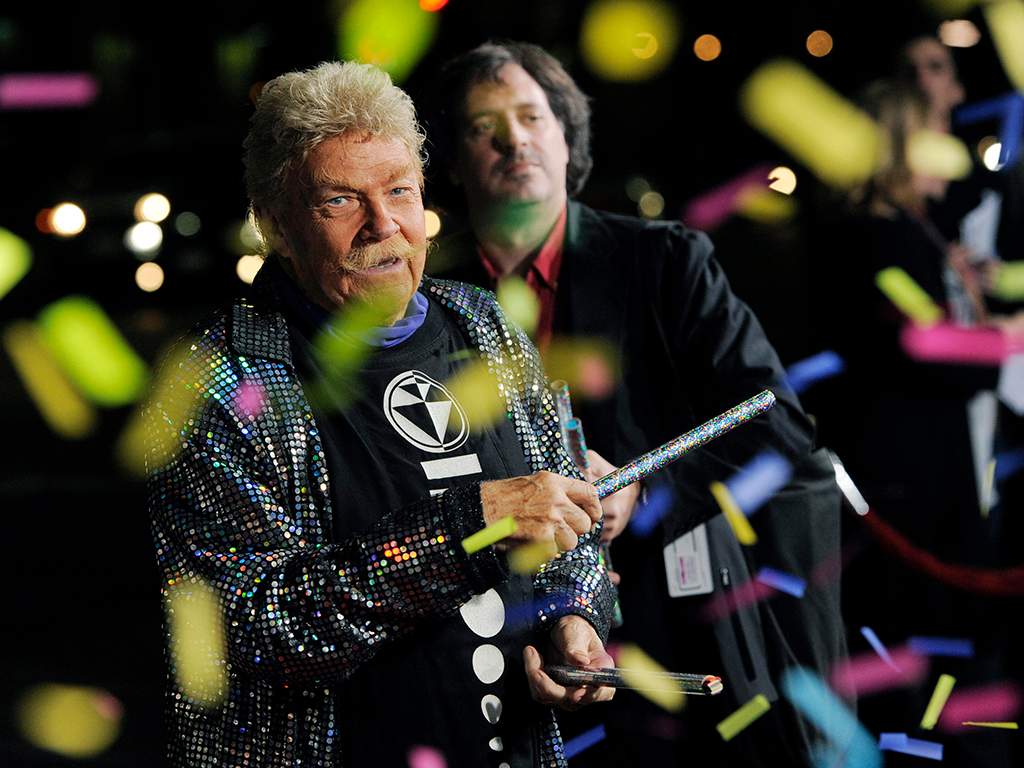 In this Wednesday, Oct. 13, 2010, file photo, comedian Rip Taylor throws confetti on photographers at the premiere of the film ‘Jackass 3D,’ in Los Angeles. Taylor, the mustached comedian with a fondness for confetti-throwing who became a television game show mainstay in the 1970s, died Sunday, Oct. 6, 2019. He was 88.