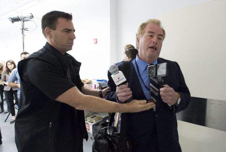 A member of the RCMP removes David Menzies, a reporter from Rebel Media, during a campaign stop for Conservative leader Andrew Scheer at the Abilities Centre in Whitby, Ont. Monday, Sept. 30, 2019. 