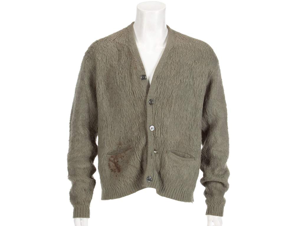 This image released by Julien’s Auctions shows an olive green cardigan sweater worn by Nirvana frontman Kurt Cobain during Nirvana’s MTV’s ‘Unplugged’ performance. The sweater, along with Cobain’s custom Fender guitar, were among many rock and roll items up for auction on Oct. 25 and 26.
