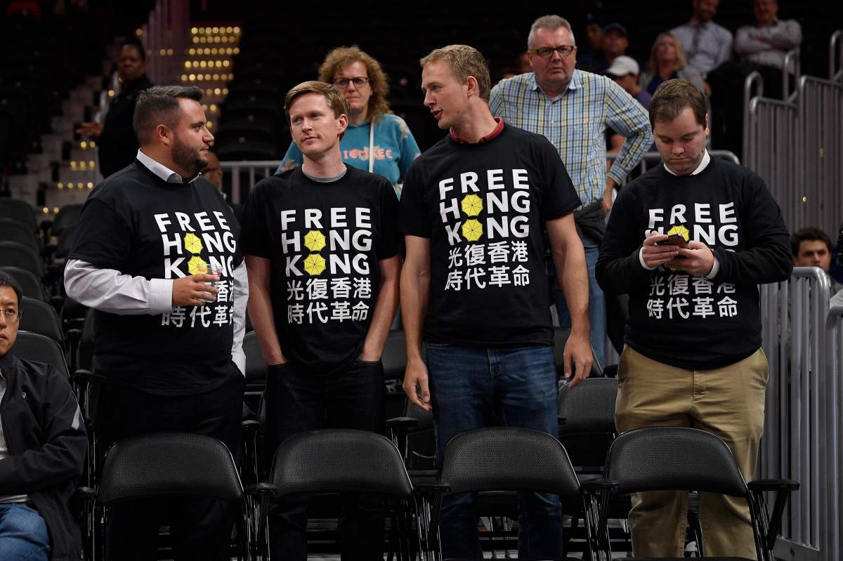 Activists wear “Free Hong Kong” T-shirts before an NBA exhibition basketball game between the Washington Wizards and the Guangzhou Loong-Lions, Wednesday, Oct. 9, 2019, in Washington.