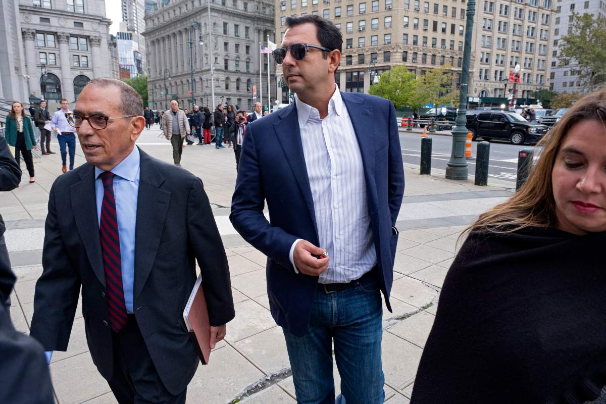 Andrey Kukushkin, center, leaves federal court, Thursday, Oct. 17, 2019, in New York. Kukushkin and David Correia pleaded not guilty Thursday to conspiring with associates of Rudy Giuliani to make illegal campaign contributions.   