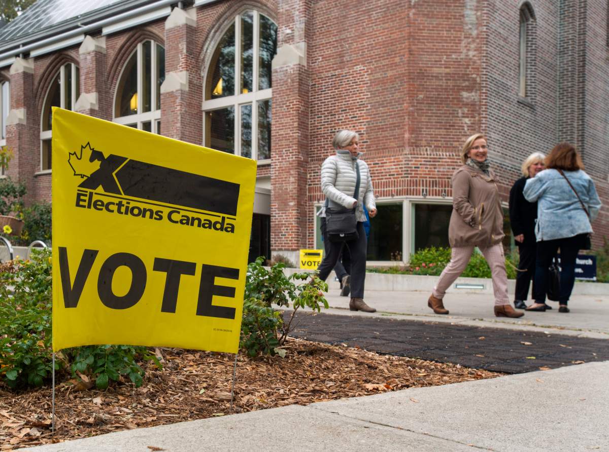 People leave a polling station in Toronto, Canada, 21 October 2019. Canadians are voting in the country's 43rd federal election this day.  EPA/WARREN TODA.