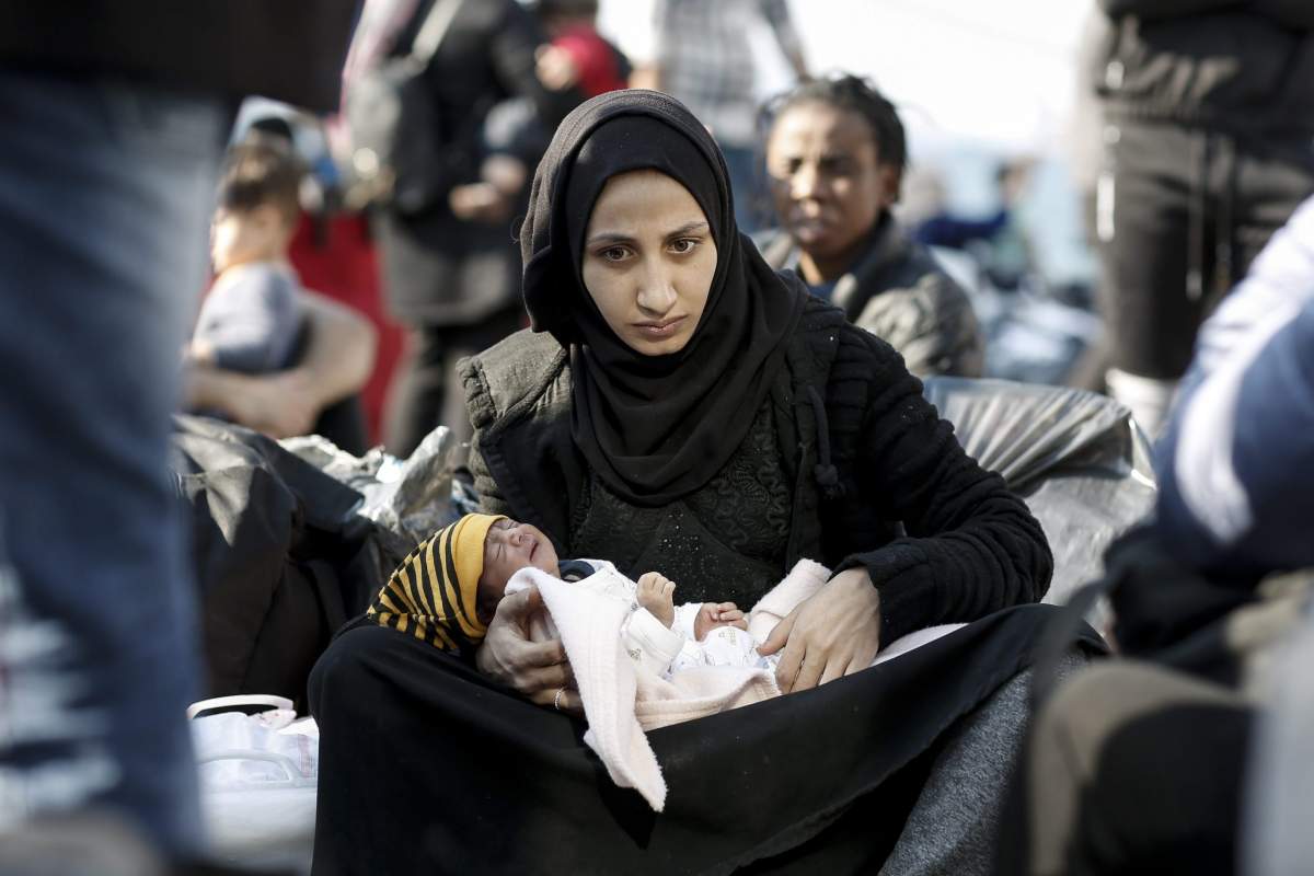 A Syrian refugee mother holds her newborn baby after disembarking from the ferry 'Paros Jet' upon their arrival from Samos Island at the port of Elefsina near Athens, Greece, 22 October 2019.