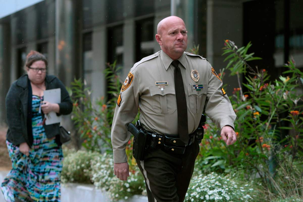 In this Oct. 24, 2019 file photo, St. Louis County police Sgt. Keith Wildhaber returns from lunch break to the St. Louis County courthouse on the third day of his discrimination case against the county in Clayton, Mo. 