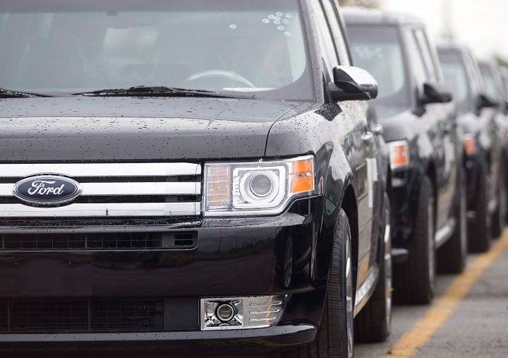 Ford Flex crossover vehicles sit in parking lots outside the production facility in Oakville, Ont., Tuesday, June 3, 2008. Ford Motor Co.'s largest Canadian manufacturing operation will eliminate 450 jobs by early 2020 as the company discontinues two of the models made at the Oakville, Ont., complex. 