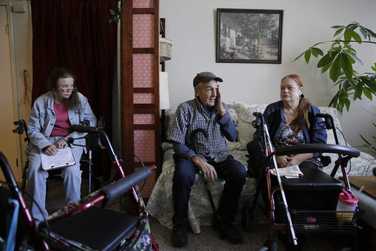 From left, Sharon Wagner-Higgins, Brian Cherry and Theresa Metzger talk about their experiences of being stranded in the dark during the power blackouts at the Villas at Hamilton housing complex for low income seniors Wednesday, Oct. 30, 2019, in Novato, Calif..