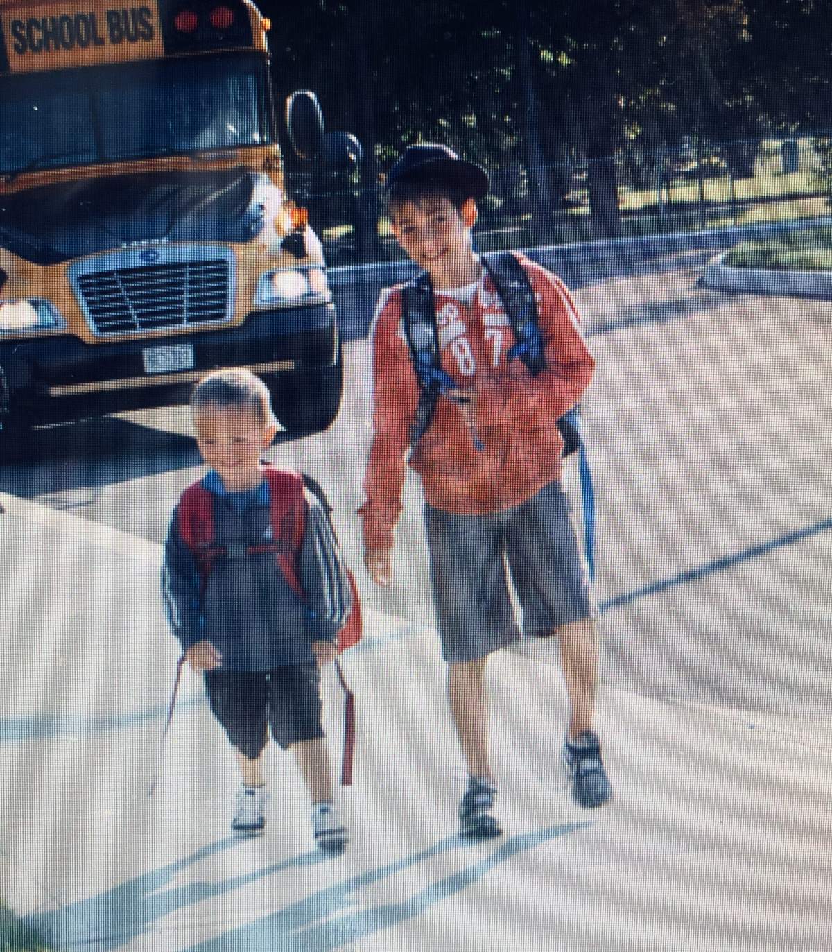 An older photo of Tyler Coleiro walking a young Jack Stafford to his first day of kindergarten.
