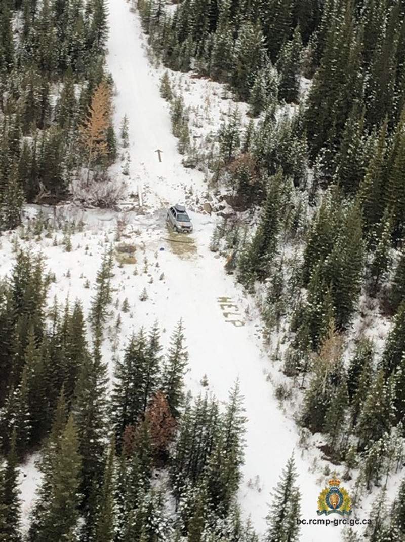 The word “help” and an arrow are seen scrawled into the snow from a RCMP aircraft that was searching for a missing couple in the southeast B.C. backcountry on Oct. 31, 2019.