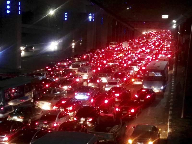 In this Tuesday, Oct. 22, 2019 photo, vehicles stop in a traffic jam due to flood waters caused by heavy rains in Cairo, Egypt. Many people, including two children, were killed in Egypt's Nile Delta region, authorities said Wednesday after heavy rains pummeled Cairo and other parts of the country the previous day, causing massive traffic jams and flooding many key roads.