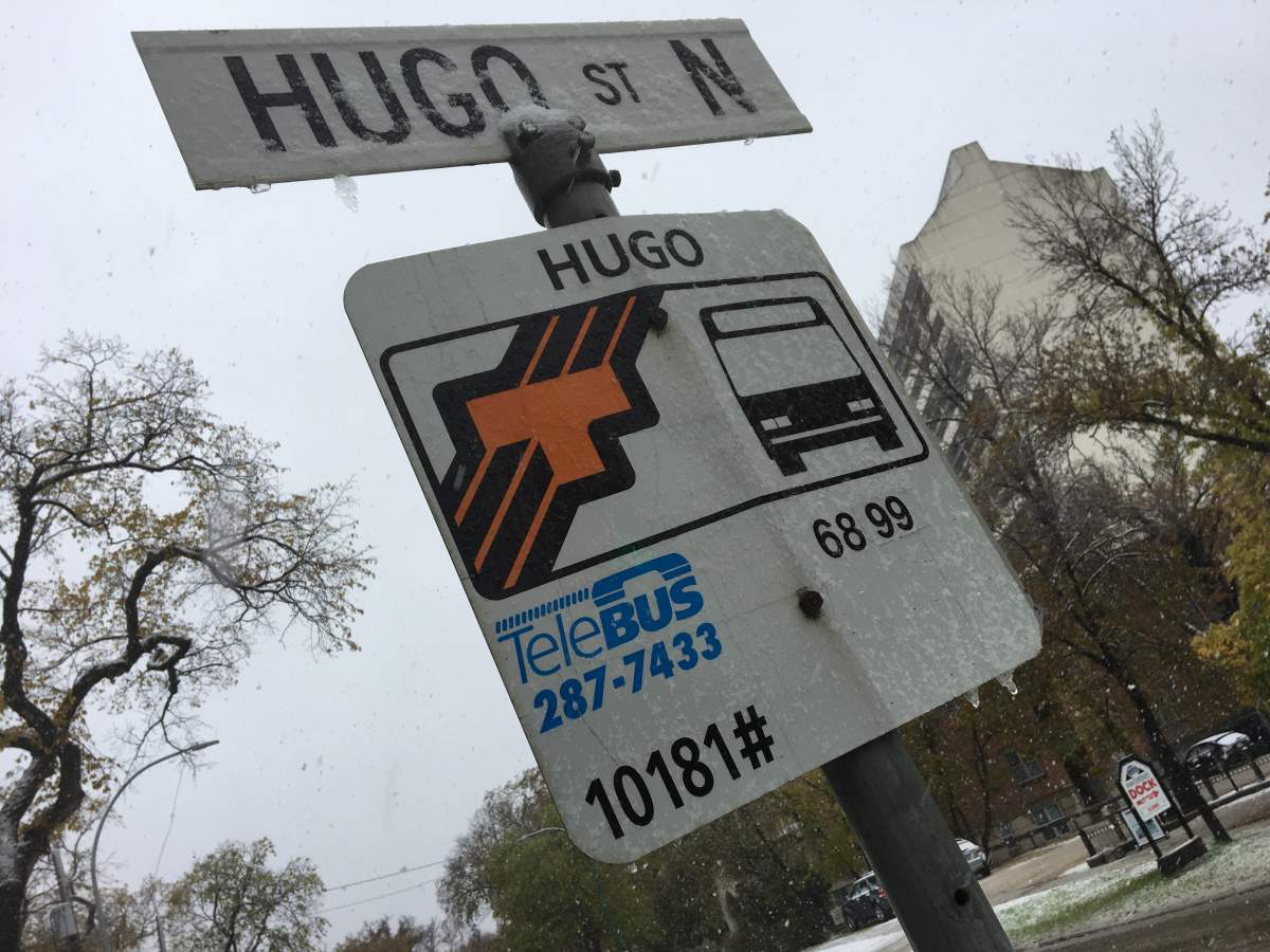 Snow on a Winnipeg Transit bus stop sign.