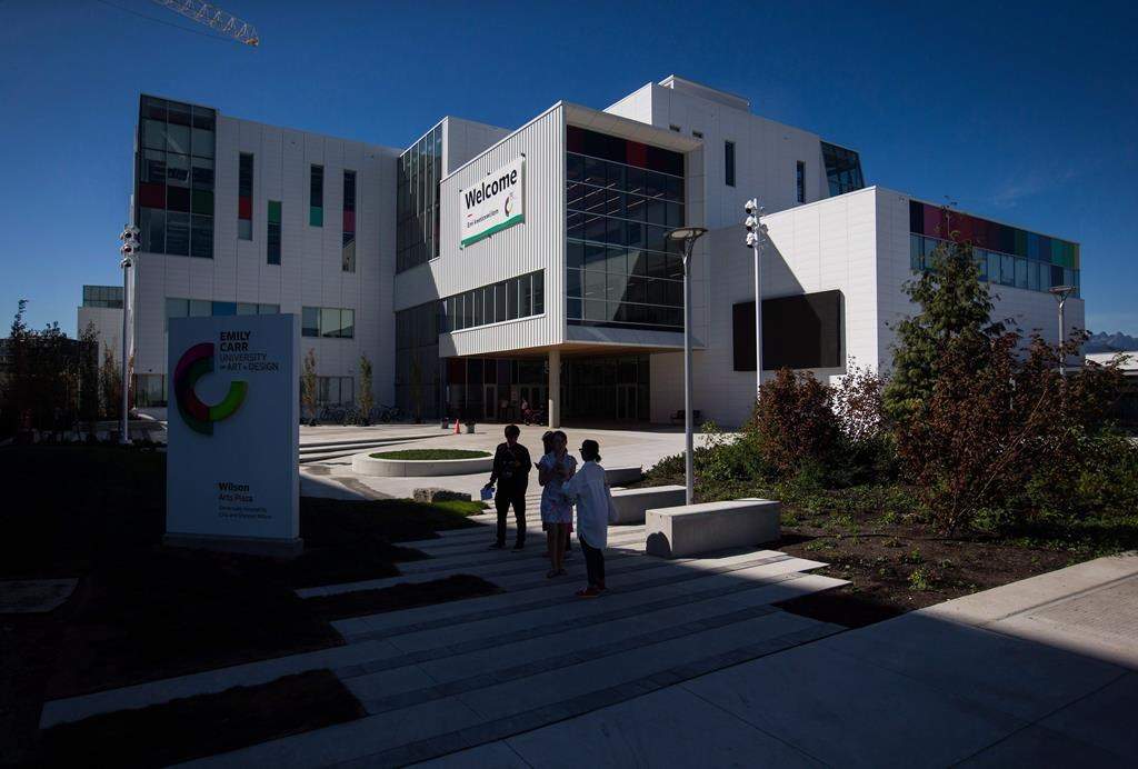 People stand outside the new Emily Carr University of Art and Design campus in Vancouver, B.C., on Friday September 1, 2017. The university campus remains closed today following a small fire Saturday morning.