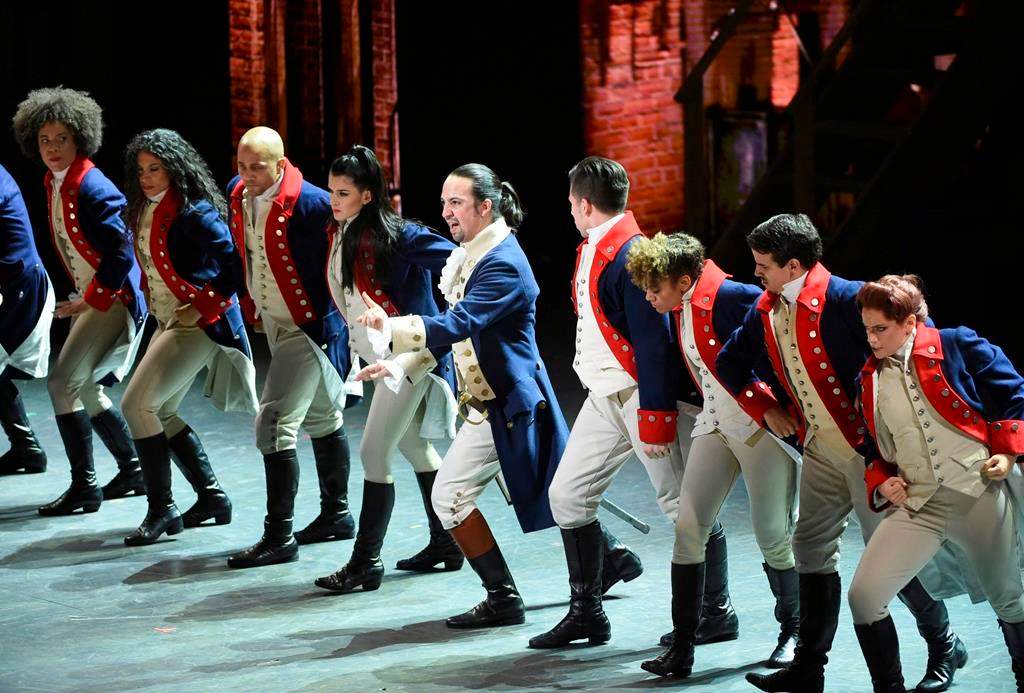 FILE - In this June 12, 2016 file photo, Lin-Manuel Miranda, center, and the cast of "Hamilton" perform at the Tony Awards in New York. Tickets for the Canadian premiere of smash musical "Hamilton" will go on sale on Oct. 28. THE CANADIAN PRESS/Evan Agostini/Invision/AP, File.