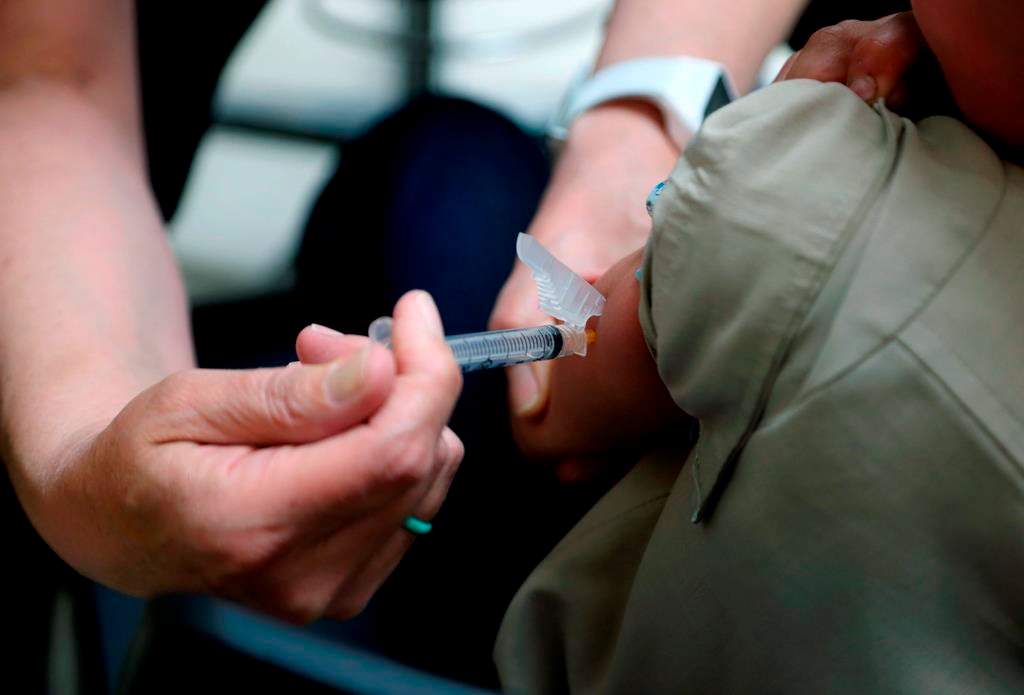 A nurse administers a vaccination to a child in this Friday, May 17, 2019.