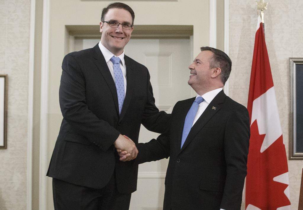 Alberta premier Jason Kenney shakes hands with Jason Nixon, Minister of Environment and Parks after being sworn into office, in Edmonton on Tuesday, April 30, 2019. Alberta has introduced a new climate plan for the province’s big greenhouse gas emitters. Nixon says it will achieve what he calls similar emissions cuts to the old government’s plan but at less cost to industry. THE CANADIAN PRESS/Jason Franson