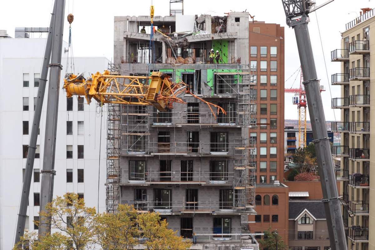 Shortly after noon on Oct. 26, 2019, the final piece of a collapsed construction crane is lowered off the building it fell on more than a month ago.