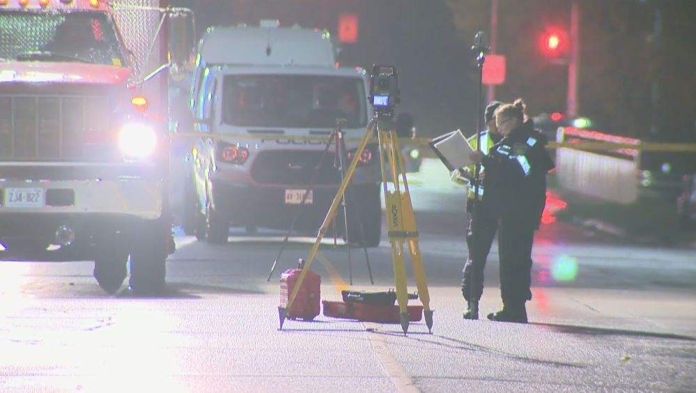 Investigators at the scene of the collision Saturday.