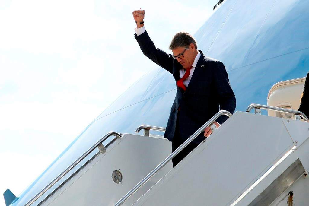 Energy Secretary Rick Perry gestures as he arrives on Air Force One with President Donald Trump at Naval Air Station Joint Reserve Base in Fort Worth, Texas, Thursday, Oct. 17, 2019.