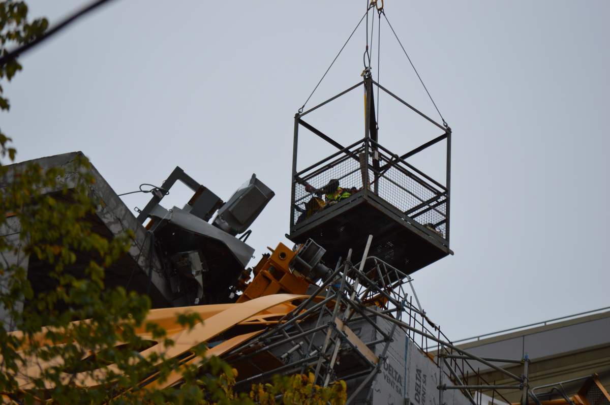 Work crews begin dismantling pieces of the toppled crane.