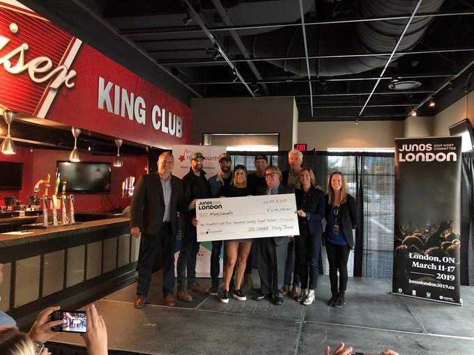 Officials are joined by The Reklaws and Dean Brody to present a cheque of more than $200,000 from the 2019 London JUNOS Host Committee to MusiCounts.