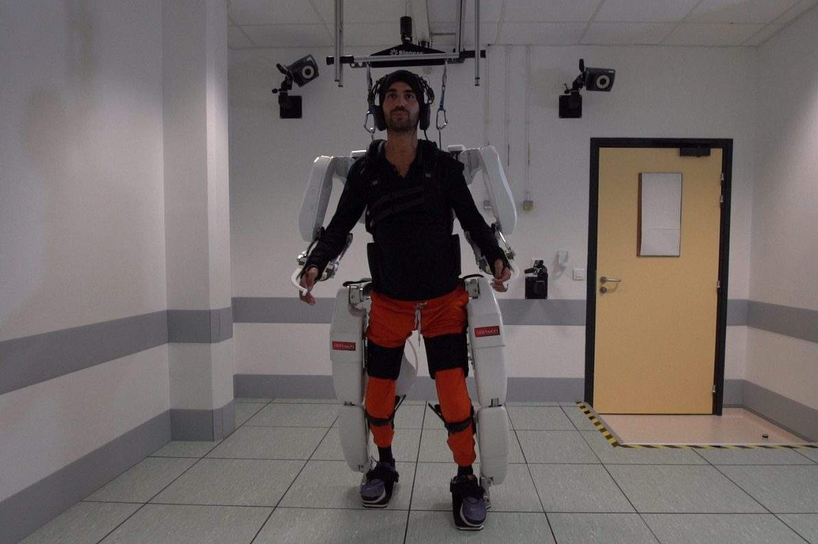 A patient with tetraplegia walks using an exoskeleton in Grenoble, France, in February 2019 in this still image taken from a video handout.