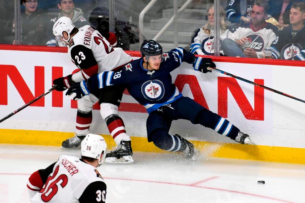 Winnipeg Jets' Jack Roslovic (28) and Arizona Coyotes' Oliver Ekman-Larsson (23) collide during third period NHL action in Winnipeg on Tuesday, Oct. 15, 2019. THE CANADIAN PRESS/Fred Greenslade.