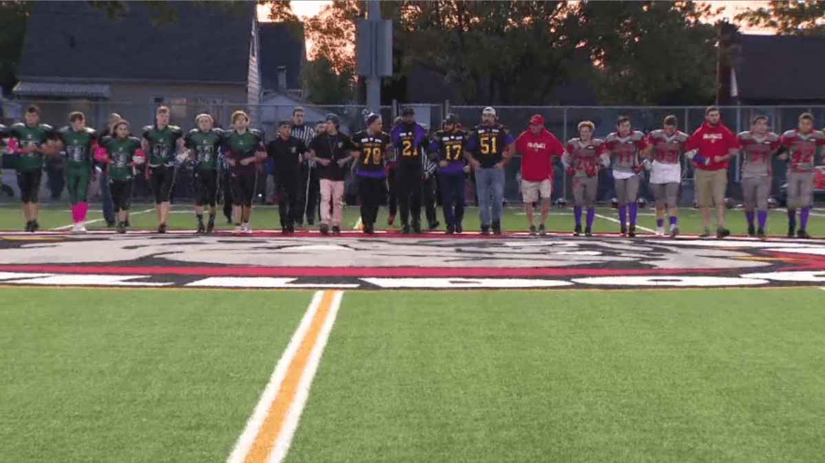 Two teams showed unity during a football game at the school where a 16-year-old was fatally stabbed days before.