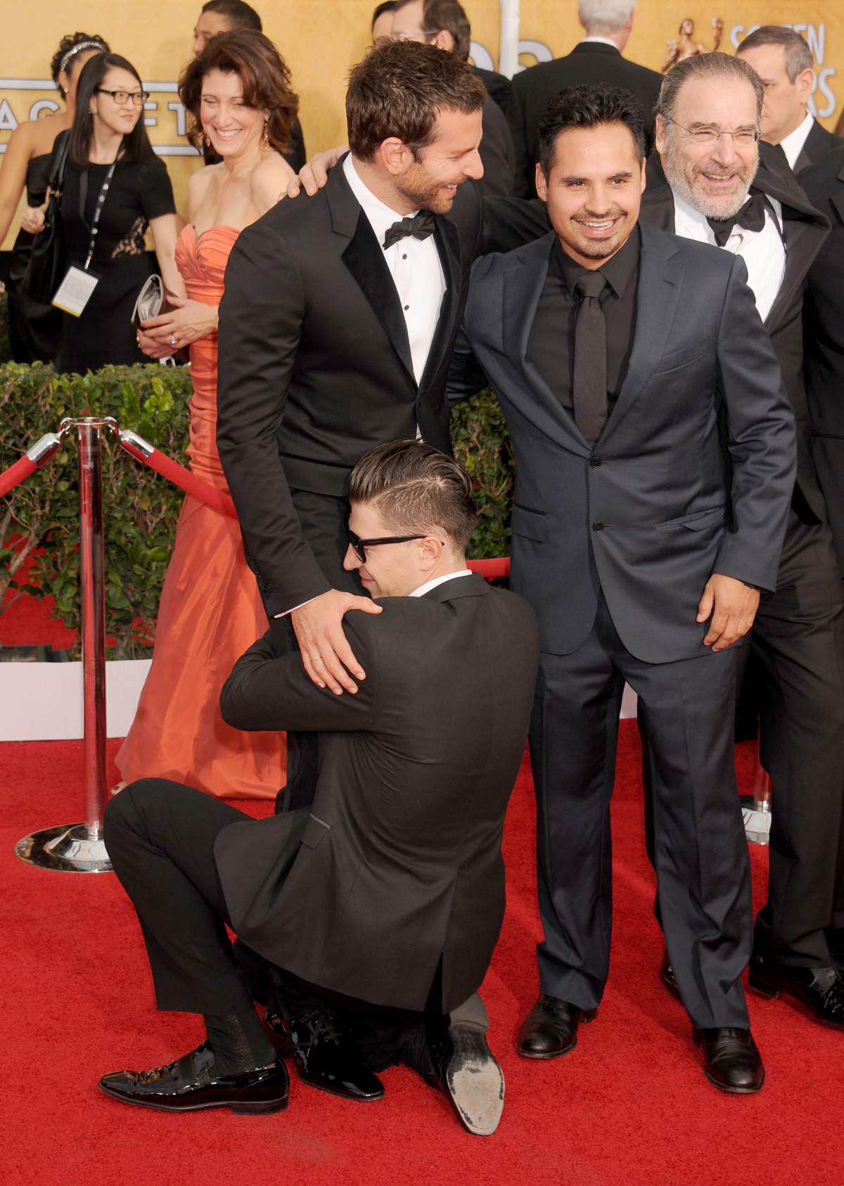 LOS ANGELES, CA – JANUARY 18: Actors Bradley Cooper, Michael Pena (R) and Vitalii Sediuk (bottom) arrive at the 20th Annual Screen Actors Guild Awards at The Shrine Auditorium on January 18, 2014 in Los Angeles, California. (Photo by Gregg DeGuire/WireImage)