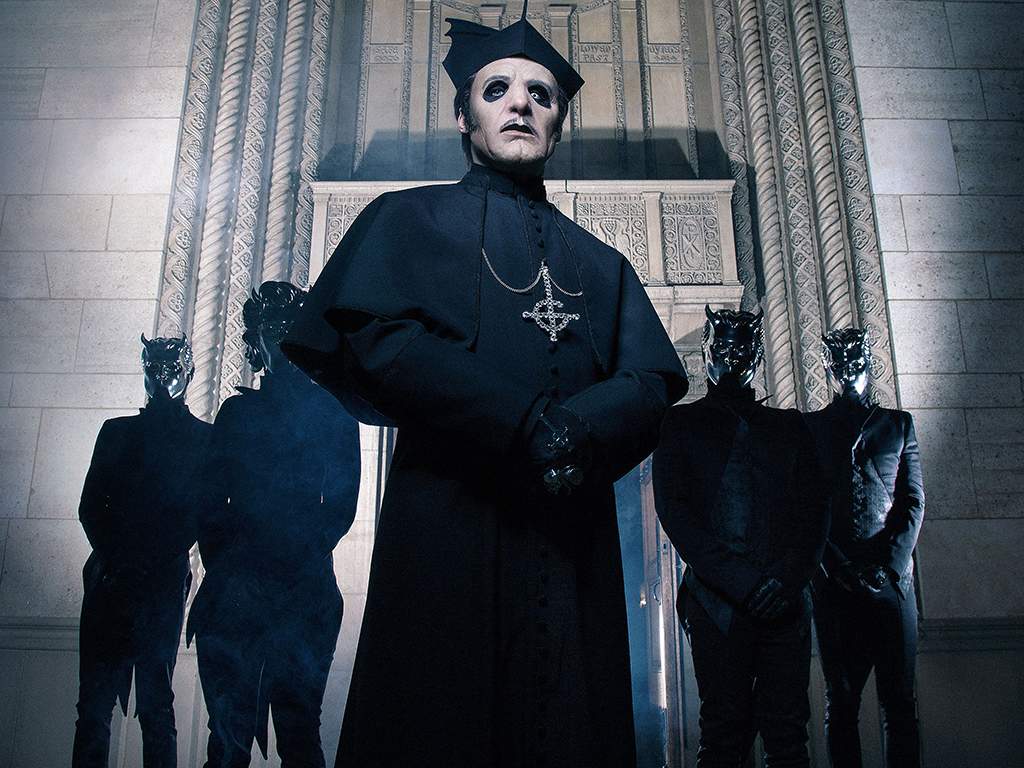 Ghost: Tobias Forge as Cardinal Copia (C) with his backing band, the "Nameless Ghouls," in 2019.
