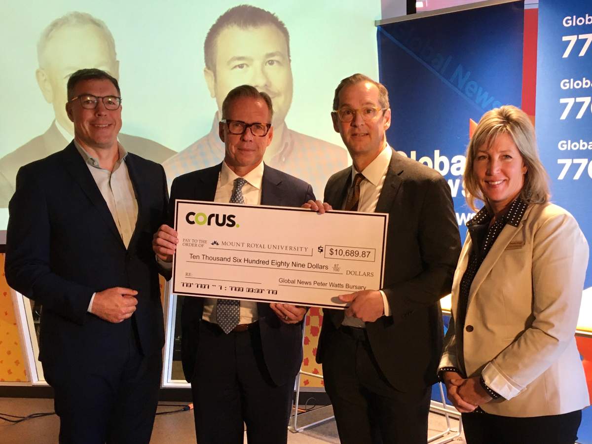 Troy Reeb and Doug Murphy of Corus Entertainment, MRU's Brad Clark and SAIT's Dr. Raynie Wood (L to R) hold a check on Oct. 1, 2019 at Corus Centre in Calgary. MRU and SAIT journalism students will soon have access to scholarships in the name of Peter Watts and John Himpe, respectively.