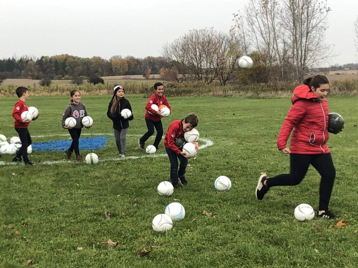 Kids at the Tricar Group ground breaking for the soccer field for FC London on Cornel Talbot Road.