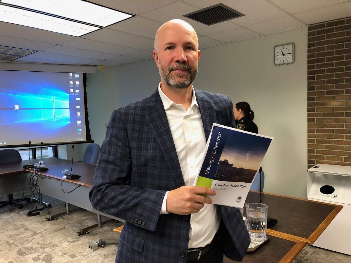 City planner John Fleming poses a report on the plan that will go before a city committee next week.