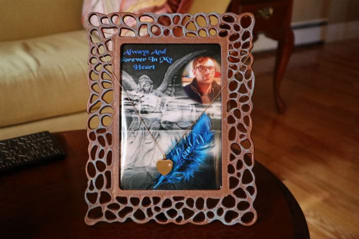 Coombs’ locket carrying her son’s ashes is laid over a picture of him in her Penetanguishene home.