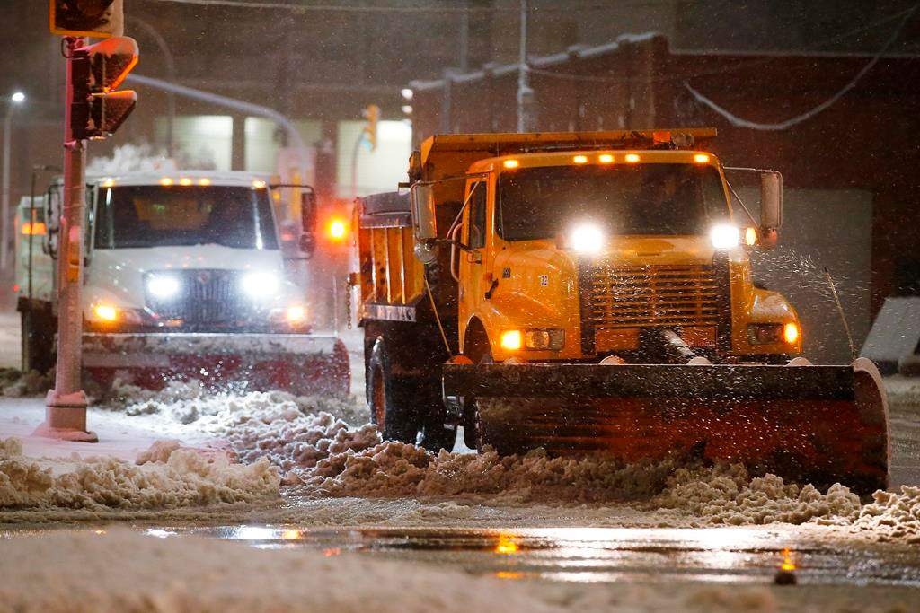 Crews seen cleaning up following a winter storm in this 2019 file photo. THE CANADIAN PRESS/John Woods.
