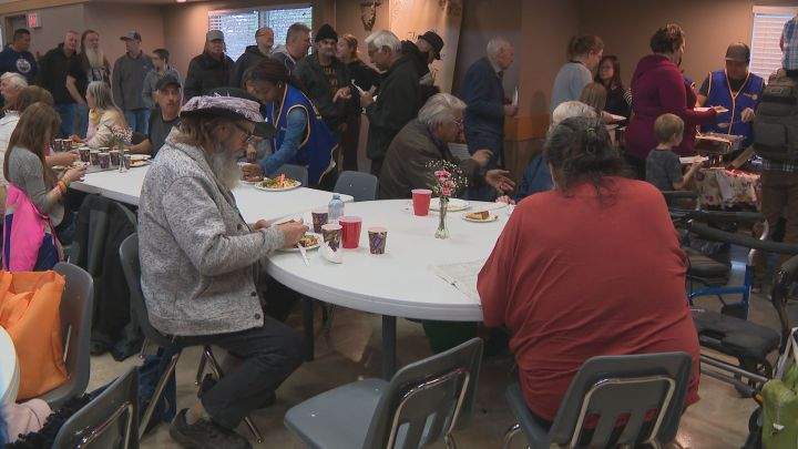 Allan Andkilde (L) enjoys the Millbourne Laundromat Thanksgiving dinner on Monday, Oct. 14, 2019 at the Leefield Community Hall in south Edmonton.
