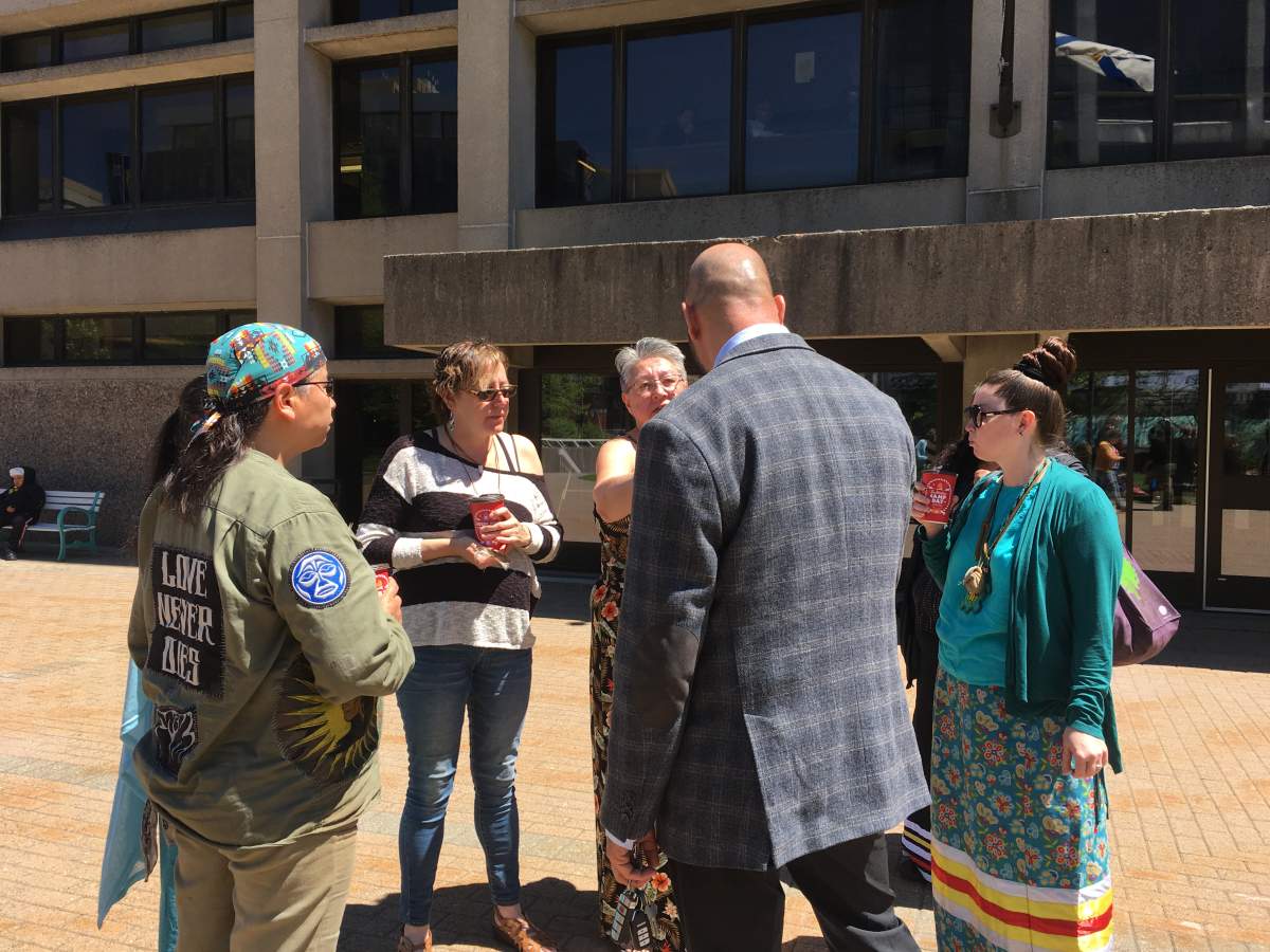 Mi'kmaq grandmothers accused of trespassing on land owned by Alton Gas confer with lawyer Michael McDonald outside Nova Scotia Supreme Court in Halifax on June 10, 2019.