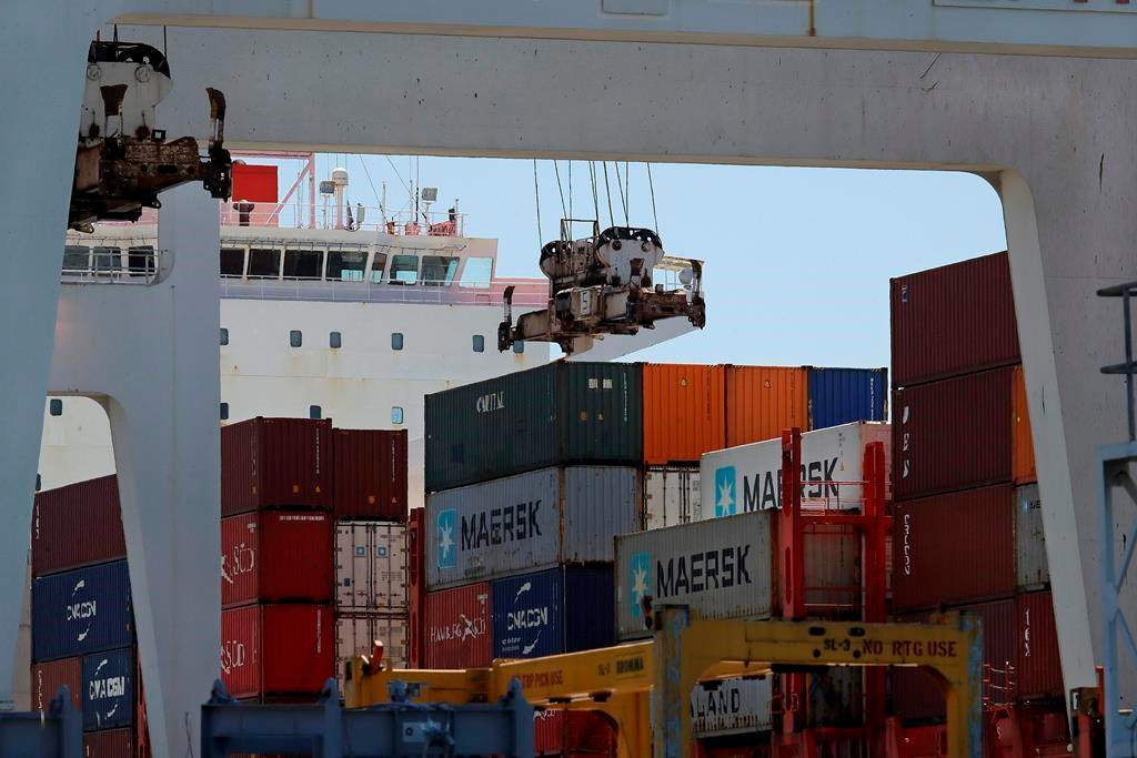 In this July 22, 2019 photo, the container ship Kota Ekspres is unloaded at the Port of Oakland in Oakland, Calif.